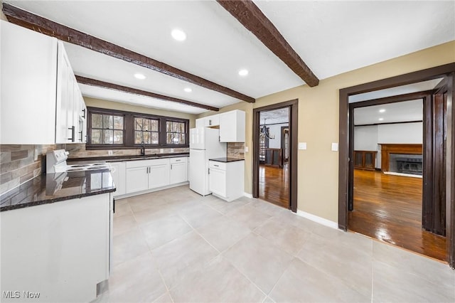 kitchen featuring backsplash, white cabinets, white appliances, and light wood-type flooring