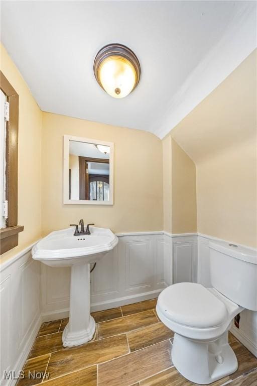 bathroom featuring wood-type flooring and toilet