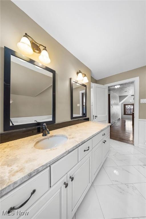 bathroom with vanity and lofted ceiling