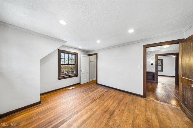 interior space with wood-type flooring and a textured ceiling