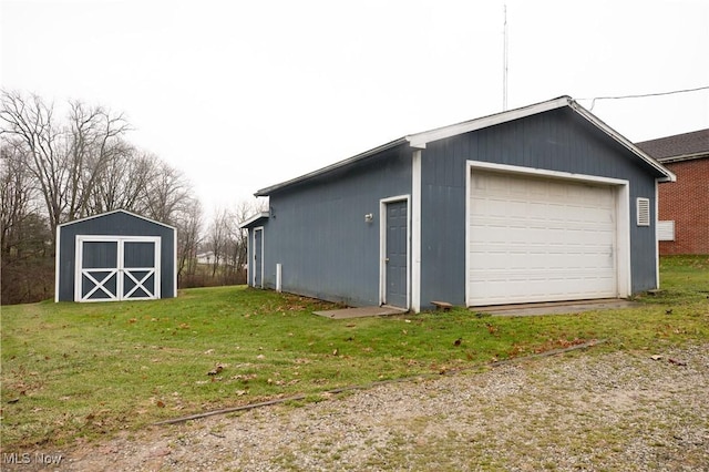 detached garage featuring a storage shed