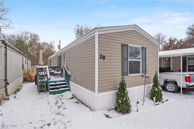 snow covered property with a wooden deck