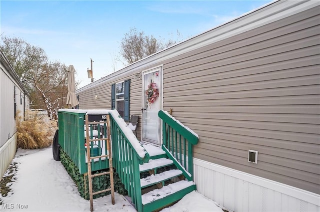 view of snow covered property entrance