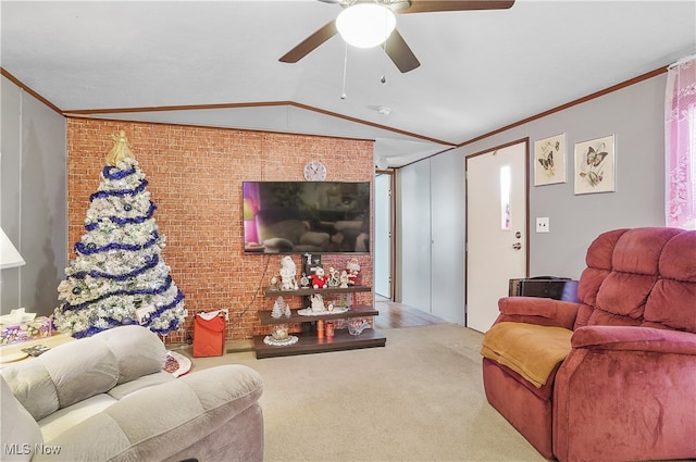 carpeted living room with ceiling fan, crown molding, brick wall, and vaulted ceiling