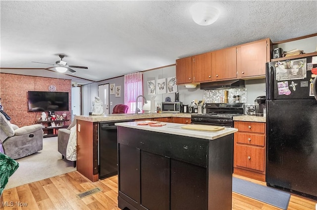 kitchen featuring ceiling fan, light hardwood / wood-style flooring, kitchen peninsula, a textured ceiling, and black appliances