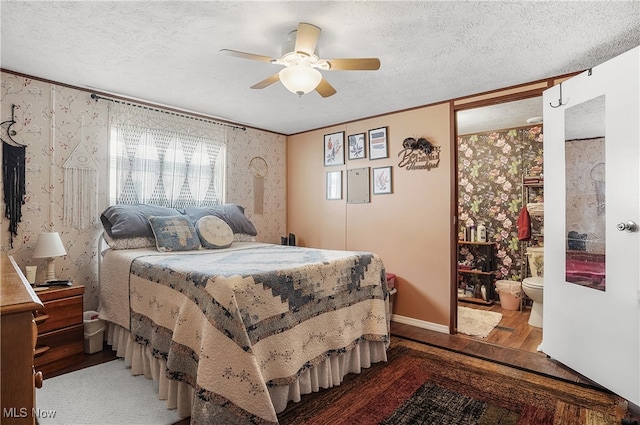 bedroom with ensuite bath, a textured ceiling, ceiling fan, crown molding, and hardwood / wood-style flooring