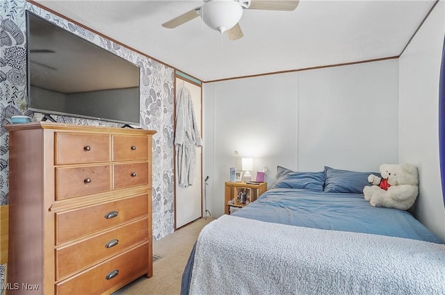 bedroom featuring ceiling fan, crown molding, and light colored carpet