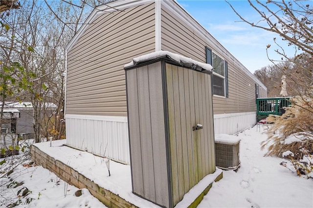 view of snowy exterior with central air condition unit