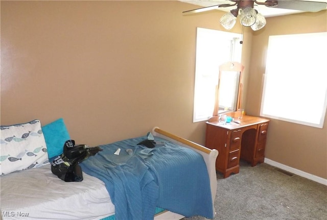 bedroom featuring light carpet and ceiling fan