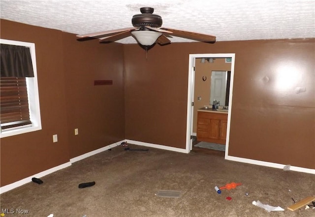 carpeted spare room featuring a textured ceiling