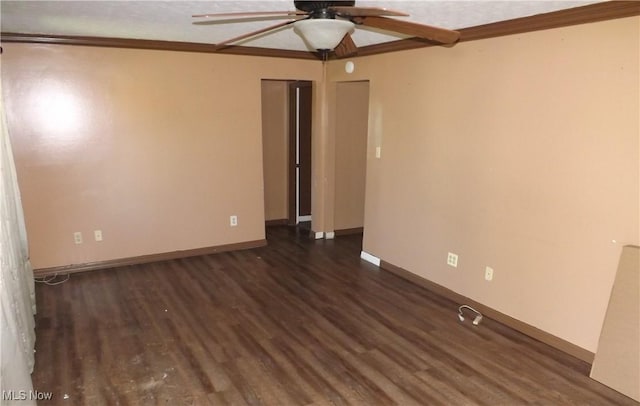 empty room featuring ceiling fan, dark hardwood / wood-style flooring, and ornamental molding