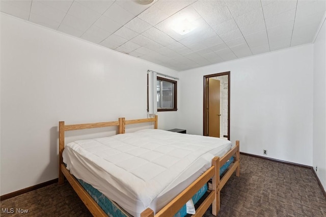 bedroom featuring dark carpet