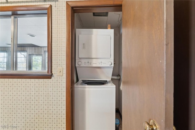 laundry area featuring stacked washer / drying machine