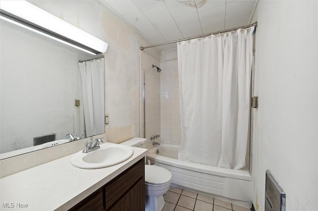 full bathroom featuring toilet, shower / tub combo with curtain, vanity, and tile patterned flooring