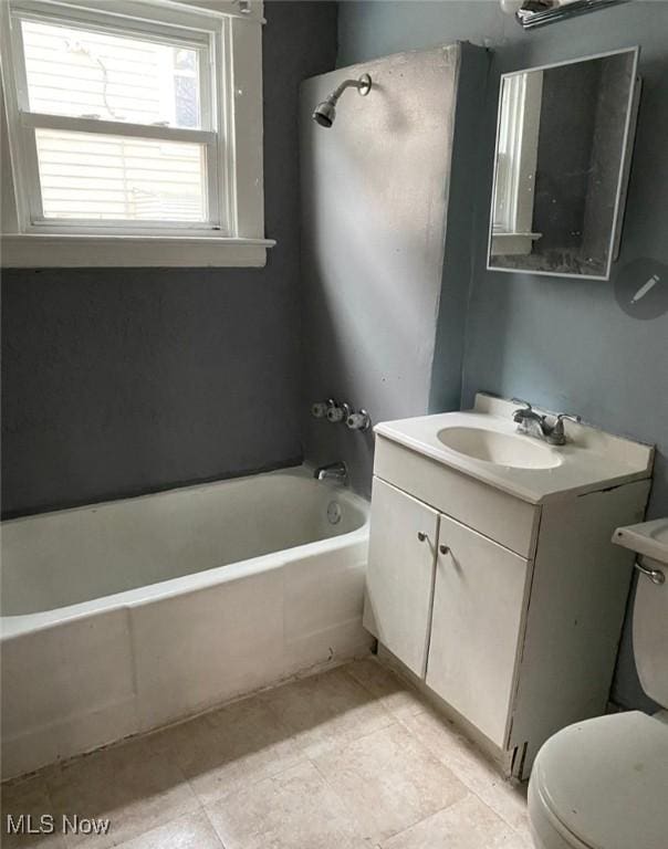 full bathroom featuring vanity, bathtub / shower combination, and toilet