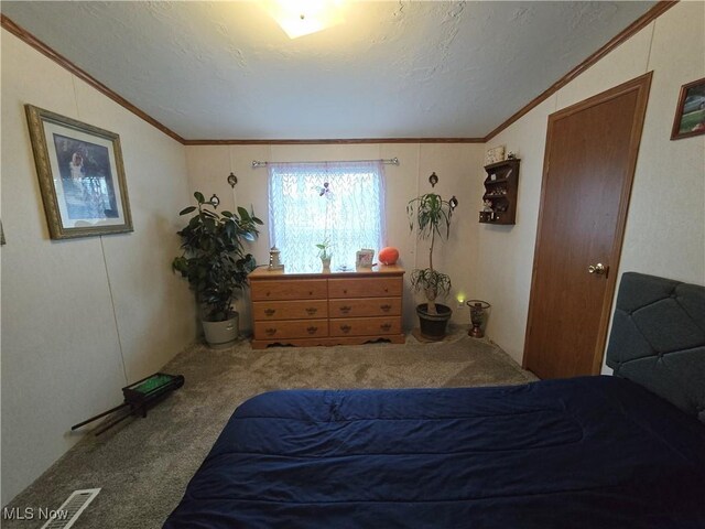 bedroom featuring carpet, ornamental molding, a textured ceiling, and lofted ceiling