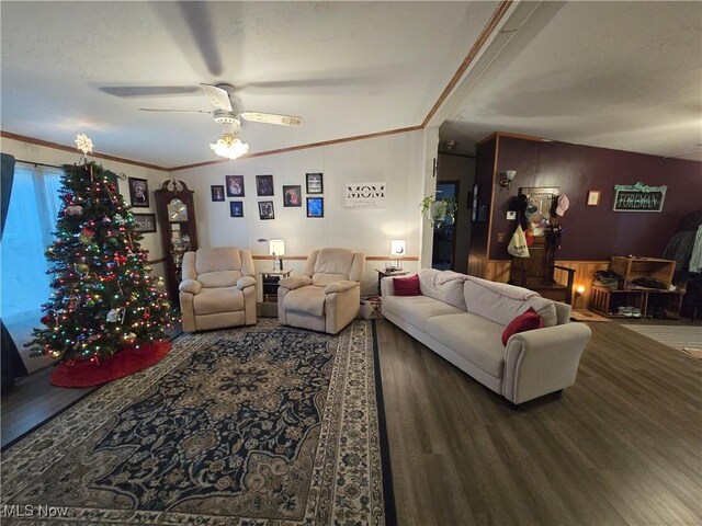 living room with hardwood / wood-style floors, ceiling fan, ornamental molding, and vaulted ceiling