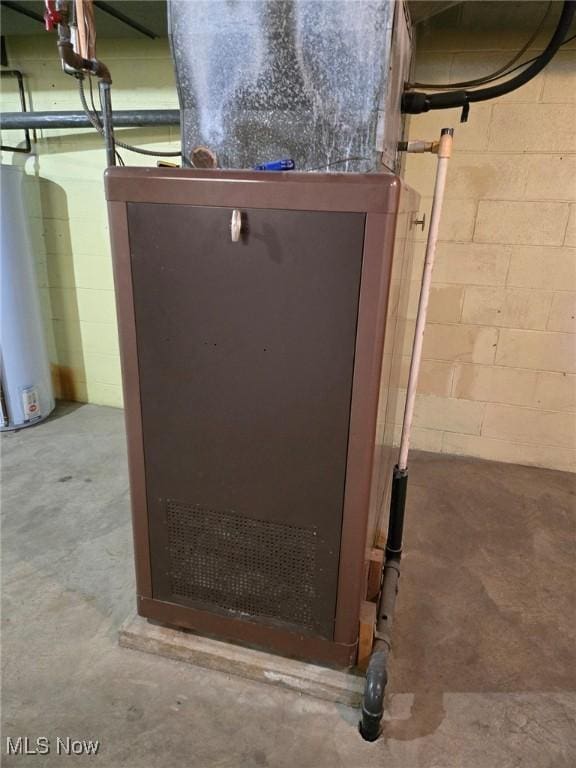 utility room featuring water heater