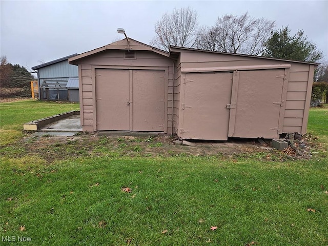 view of outbuilding featuring a yard