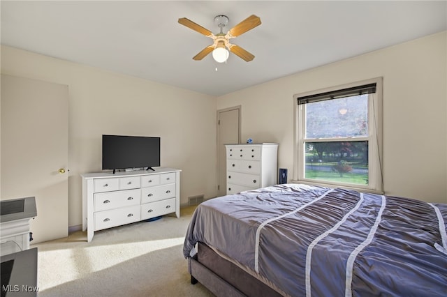 bedroom with ceiling fan and light colored carpet