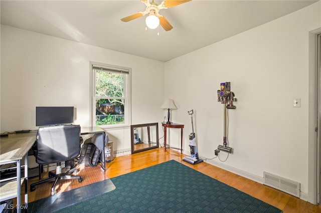 office area with light wood-type flooring and ceiling fan