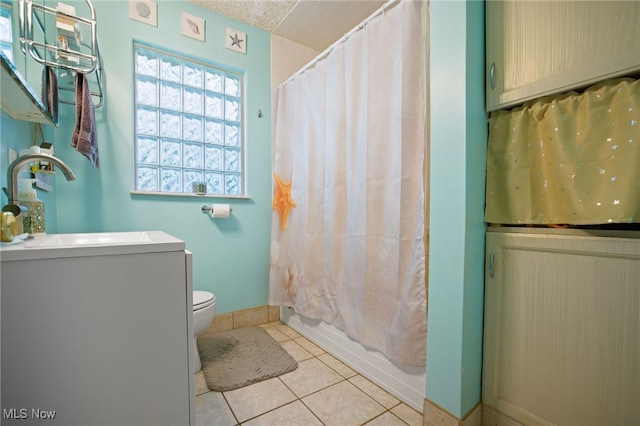 full bathroom featuring shower / bathtub combination with curtain, tile patterned flooring, a textured ceiling, toilet, and vanity