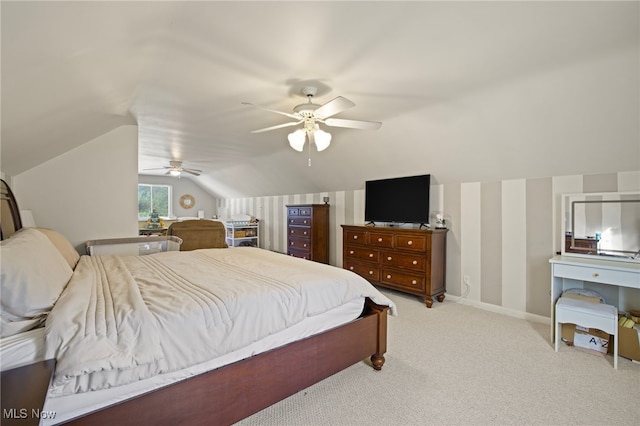 bedroom featuring light colored carpet, vaulted ceiling, and ceiling fan