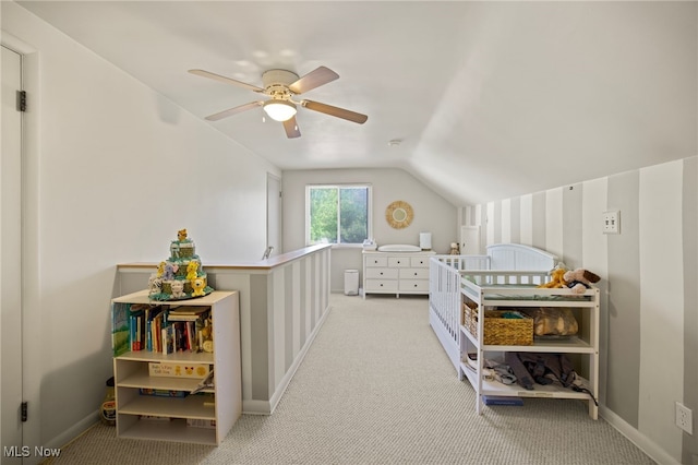 bedroom featuring light carpet, vaulted ceiling, and ceiling fan