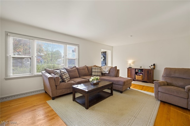 living room with hardwood / wood-style floors and a baseboard heating unit