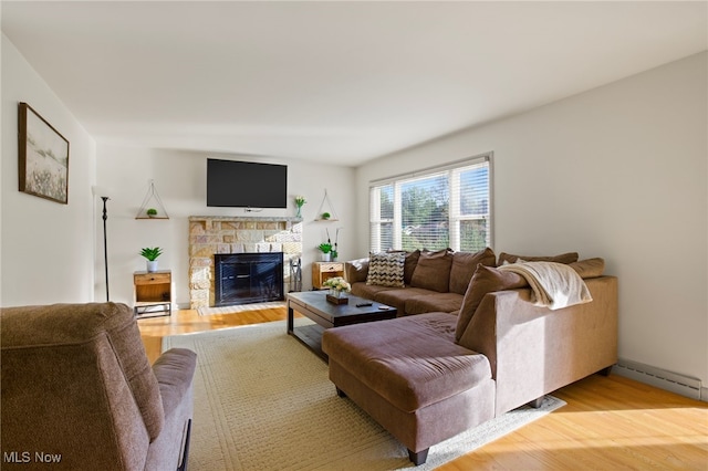 living room with a fireplace, hardwood / wood-style floors, and a baseboard radiator