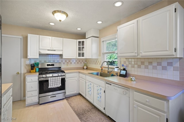 kitchen with white cabinets, white dishwasher, and stainless steel gas range oven