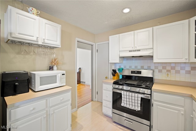 kitchen featuring light wood-type flooring, white cabinetry, and stainless steel range with gas stovetop