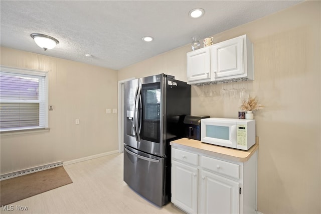 kitchen featuring light hardwood / wood-style floors, white cabinetry, stainless steel refrigerator with ice dispenser, and baseboard heating