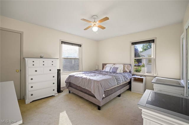 bedroom featuring light carpet and ceiling fan