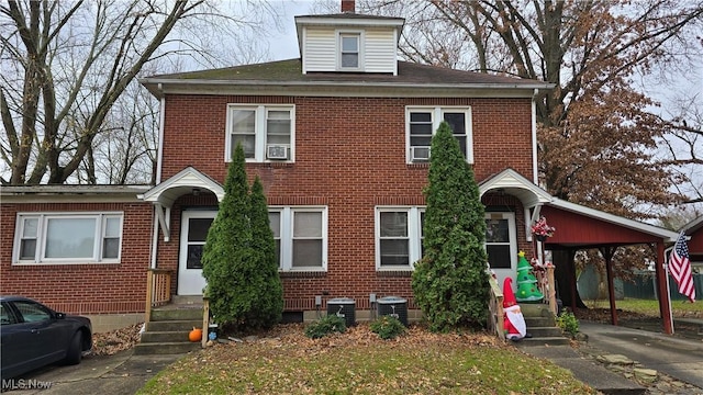 view of front of home featuring a carport and central AC