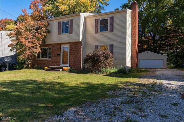 view of front of house with an outbuilding, a garage, and a front yard