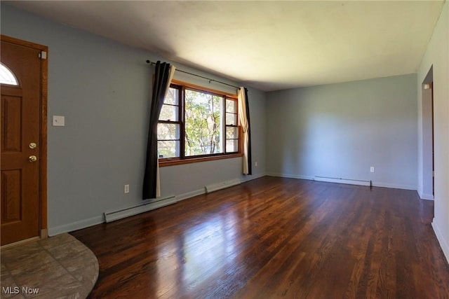 foyer entrance with dark hardwood / wood-style floors and baseboard heating