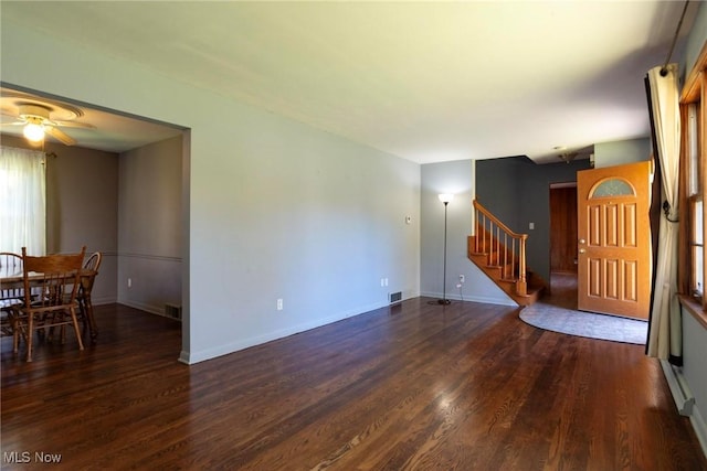 living room featuring dark hardwood / wood-style flooring and ceiling fan