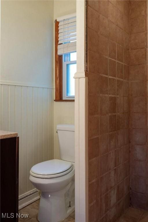 bathroom with vanity, toilet, and baseboard heating