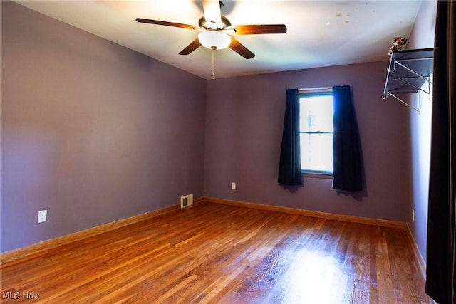 unfurnished room with ceiling fan and wood-type flooring