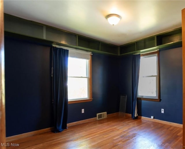 spare room with hardwood / wood-style floors