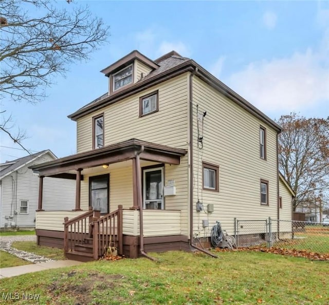 view of front of property with covered porch and a front lawn