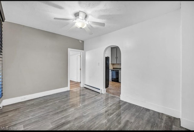 unfurnished room with dark hardwood / wood-style floors, ceiling fan, a textured ceiling, and a baseboard radiator