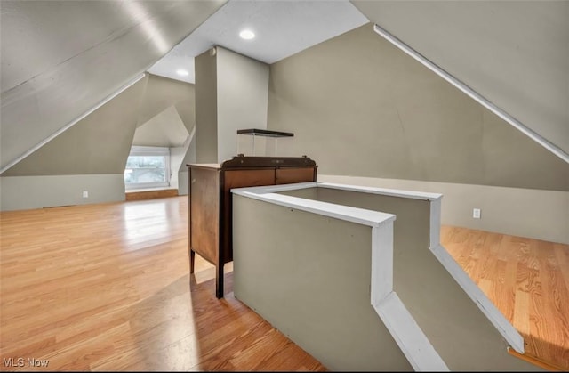 bonus room with lofted ceiling and light hardwood / wood-style flooring