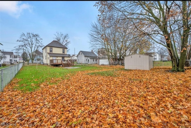 view of yard with an outbuilding and a deck