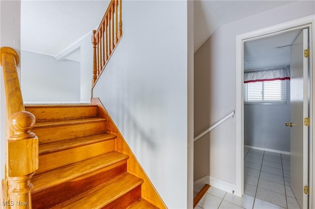 stairway featuring tile patterned flooring