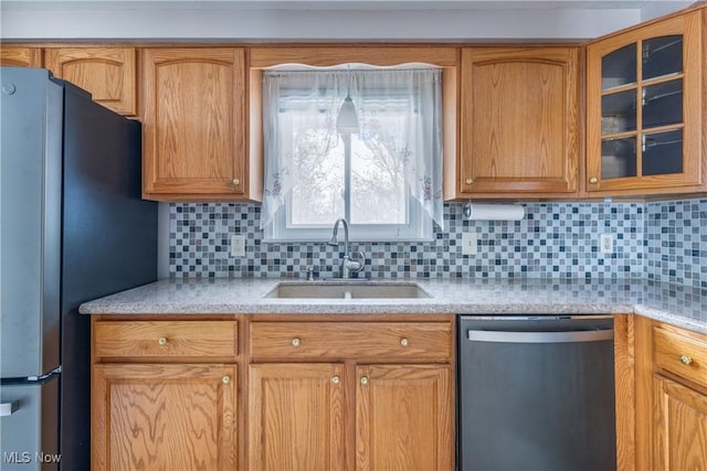 kitchen with backsplash, sink, and appliances with stainless steel finishes