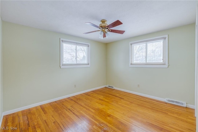 unfurnished room featuring ceiling fan, plenty of natural light, and light hardwood / wood-style floors