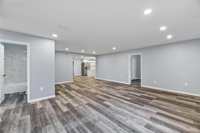 unfurnished living room with dark hardwood / wood-style floors