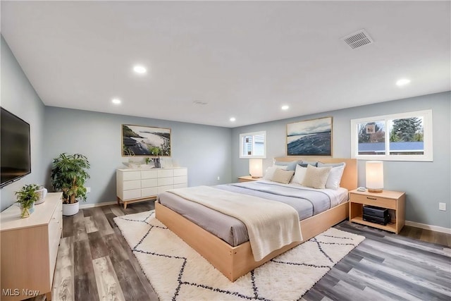 bedroom with dark hardwood / wood-style floors